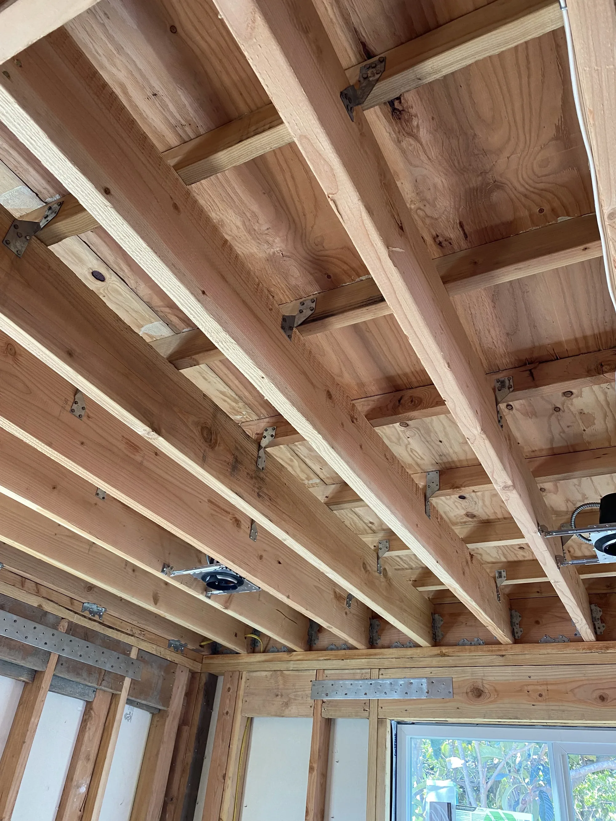 Exposed floor joists and structural framing with steel connectors